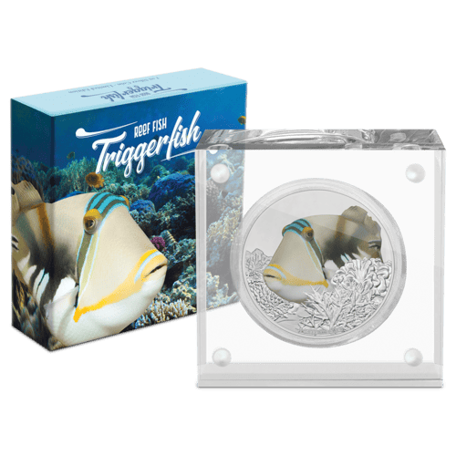 Triggerfish collectible coin with colorful underwater coral design, encased in display box, highlighting its detailed artwork and maritime theme.