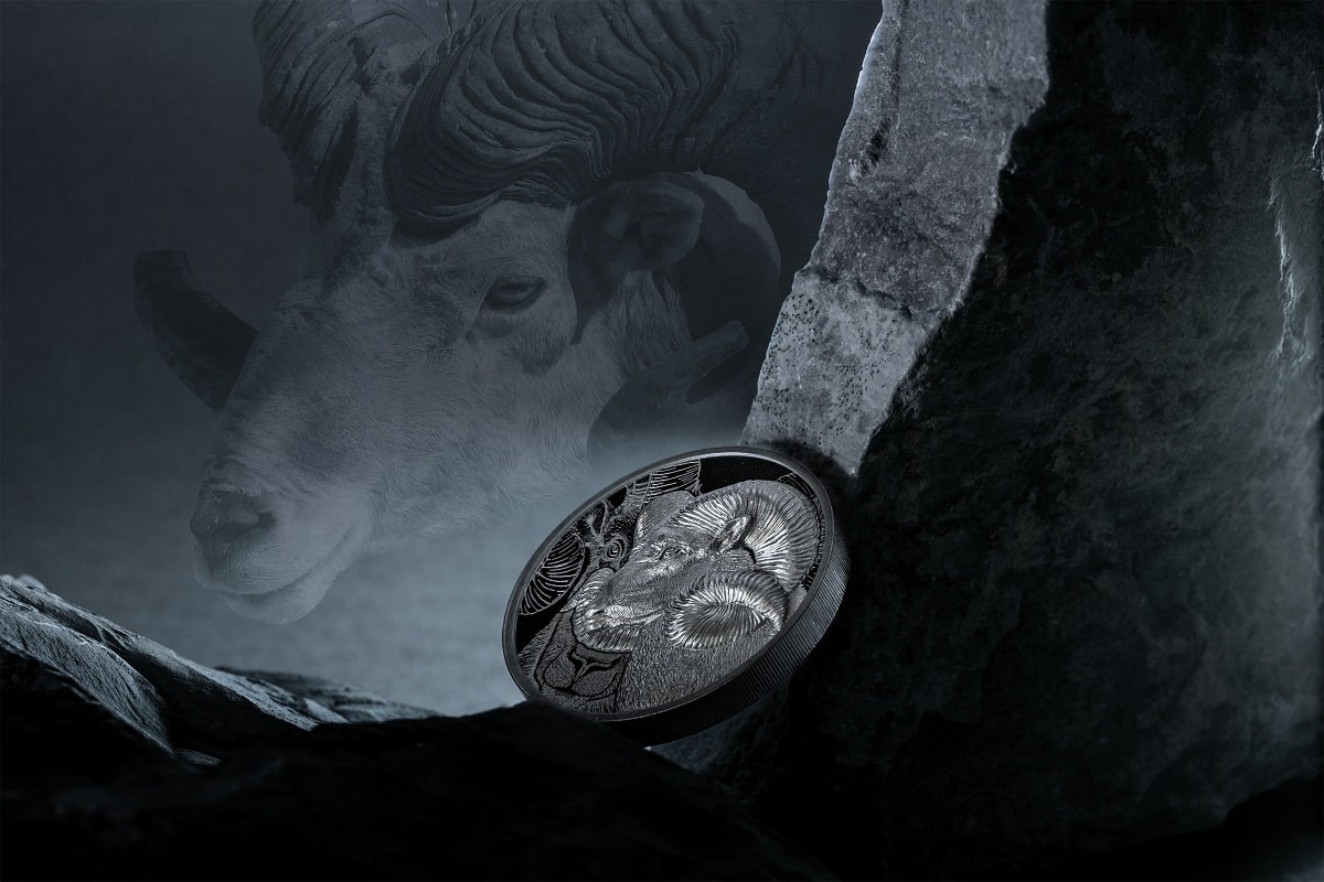 Year 2023 Chinese Zodiac Year of the Ram silver coin, featuring intricate ram design and Lunar Year motif, displayed against dark rocky background.