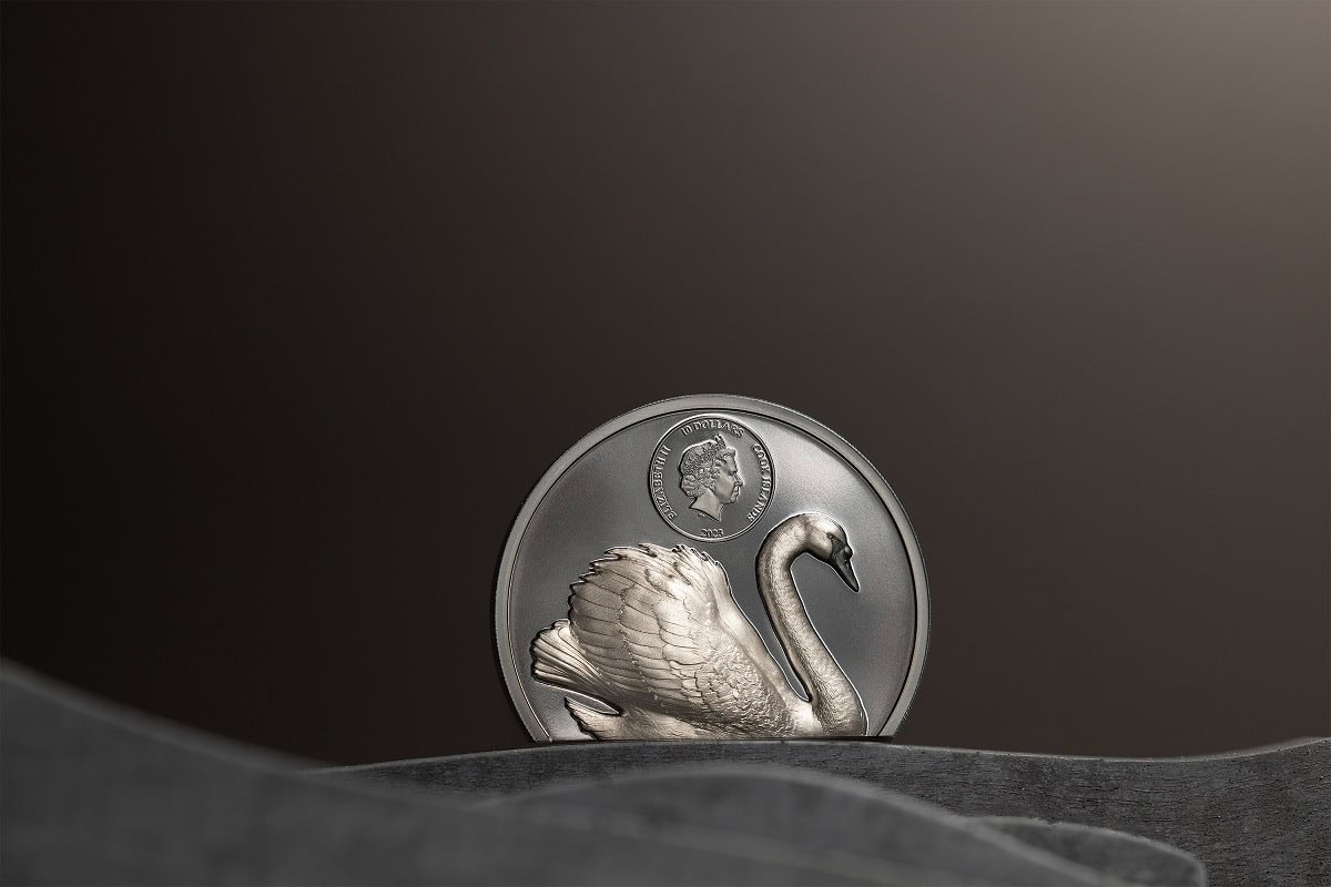 Silver collectible coin featuring a detailed swan design and a portrait of Queen Elizabeth II, 2009, Canada, dollar denomination, on a dark textured surface.