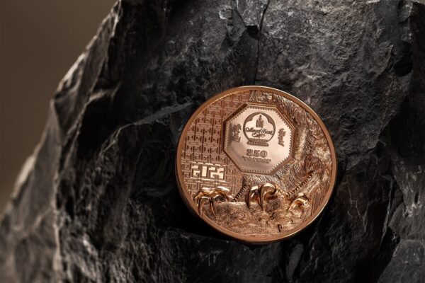 A 2023 Mongolia Wild Mongolian Falcon 50g copper proof-like coin displayed on a dark, textured, rock-like surface. The coin's front, with the falcon's head design, is clearly visible.