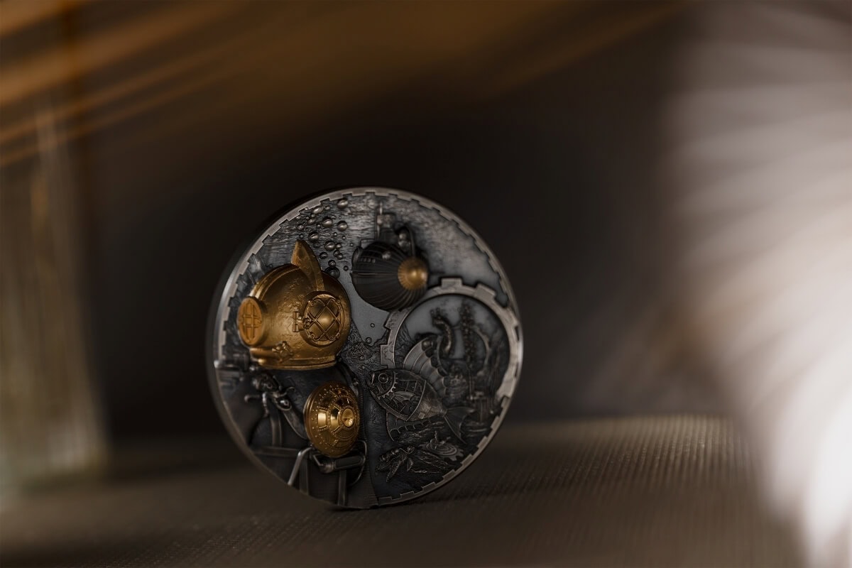 Intricate collectible coin featuring detailed maritime and nautical themes with gold accents and embossed designs, displayed on a dark surface with soft lighting.