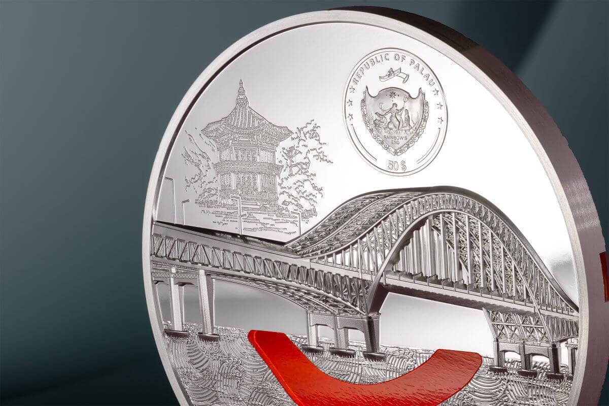 Intricate silver coin featuring a detailed image of the Rainbow Bridge in Palau, a traditional pagoda, and a Palau national crest with the year 2023.