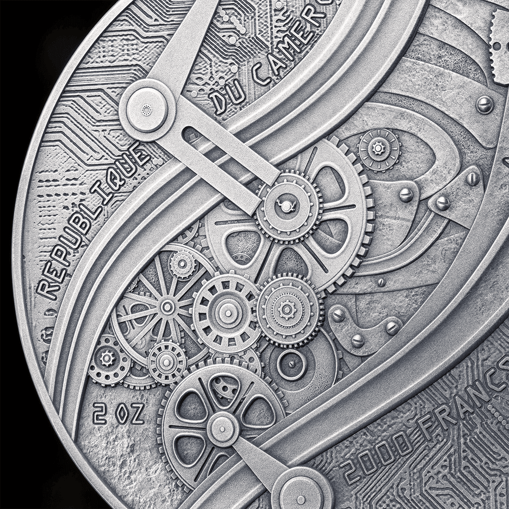 Gorgeous close-up of a silver collectible coin featuring intricate gear and circuit designs, with inscriptions "République Française," "2001," and "DU CAME R," showcasing detailed craftsmanship and mechanical artistry.