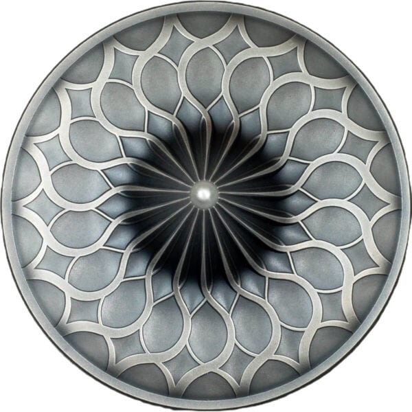 Intricate silver collectible coin with a geometric floral pattern and a central pearl-like bead, showcasing detailed craftsmanship and modern design.