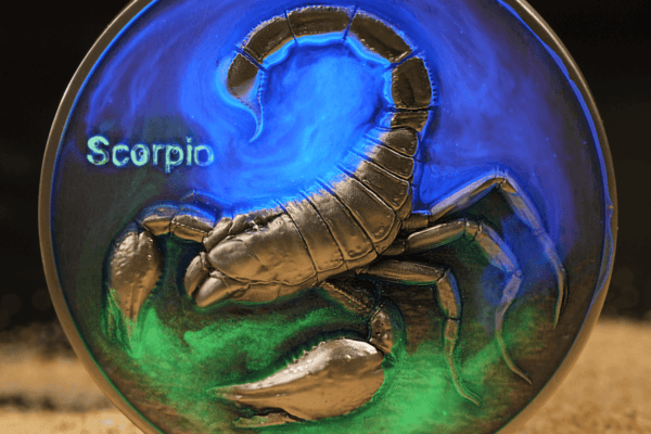 Scorpio zodiac sign coin featuring a detailed metallic scorpion with blue and green resin background, highlighting the 2023 year and collectible nature.