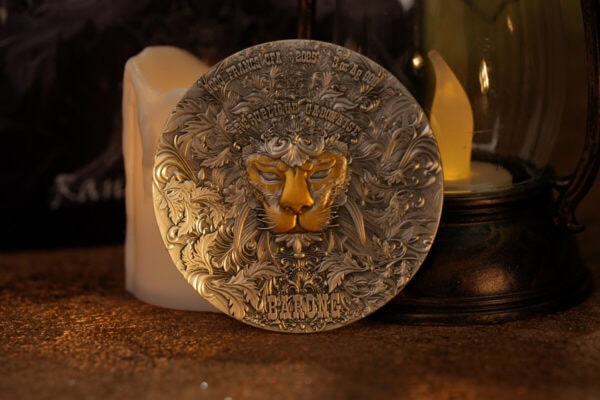 2025 Cameroon Collector Coin featuring a detailed lion's face and intricate floral patterns on a metallic surface.