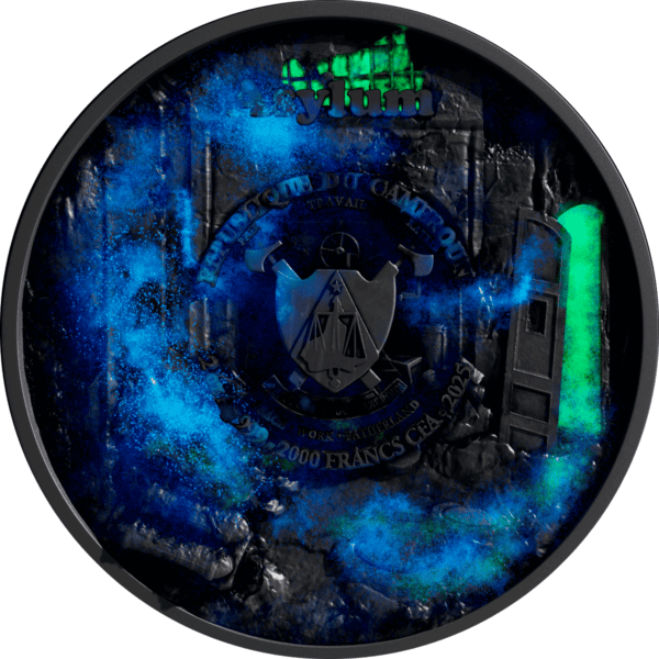 Blue and black collectible coin featuring the emblem of the French Republic with inscriptions, surrounded by a cosmic blue glow, against a dark background with metallic elements.