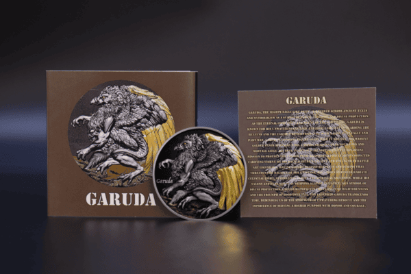 Garuda collectible coin with detailed lion and wings design, featuring a bronze and gold finish, displayed alongside its packaging.