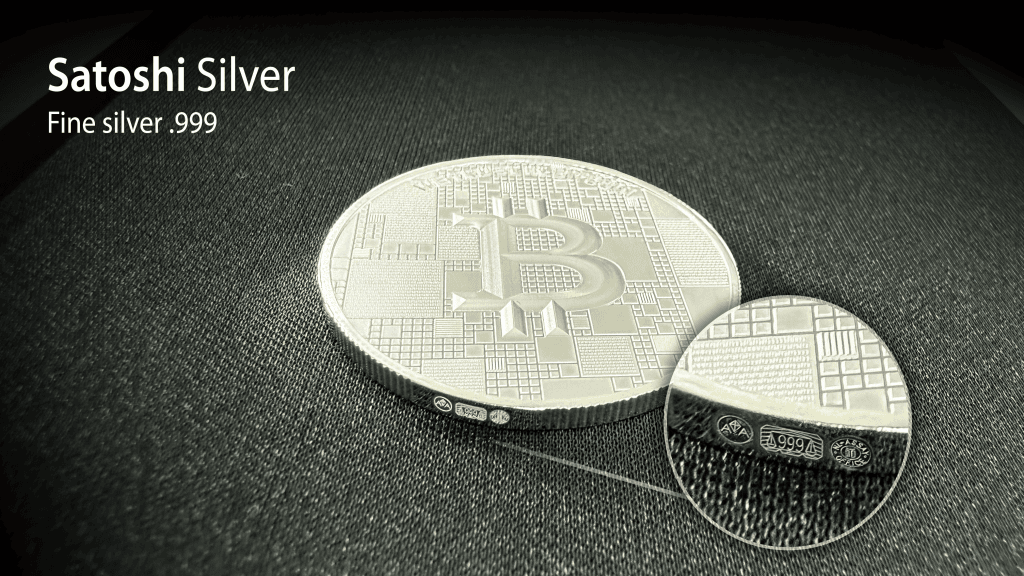 Shiny silver Bitcoin coin with digital circuit design, 21 grams, colorized, high purity .999, on a black textured surface.