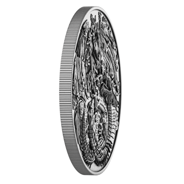 Edge view of the 2025 Niue Phoenix and Dragon 2 oz Silver Coin showing its ultra high-relief depth with sharply sculpted phoenix and dragon motifs emerging above the coin’s surface in dramatic detail.