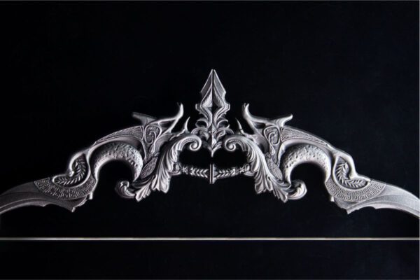 Side profile of the 2025 South Korea Divine Weapons Crescent Bow 2 oz Silver Antiqued Bar with sculptural mythological contours.