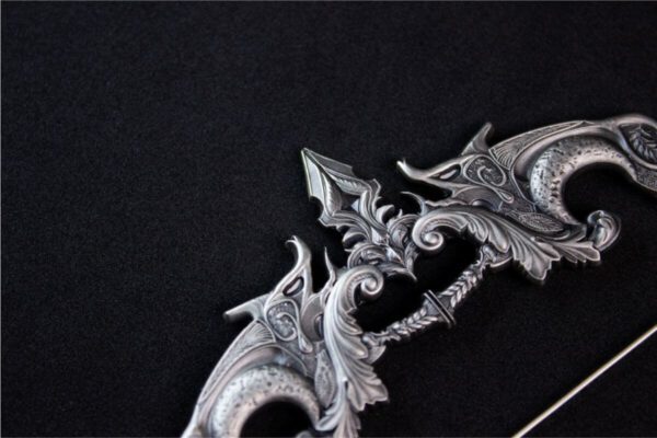 Close-up of the 2025 South Korea Divine Weapons Crescent Bow 2 oz Silver Antiqued Bar focusing on the intricately carved bow tip.
