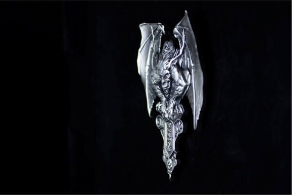 Side profile of the 2025 South Korea Gargoyle 2 oz Silver High Relief Antiqued Stacker against a black background, emphasizing depth and sculptural intensity.