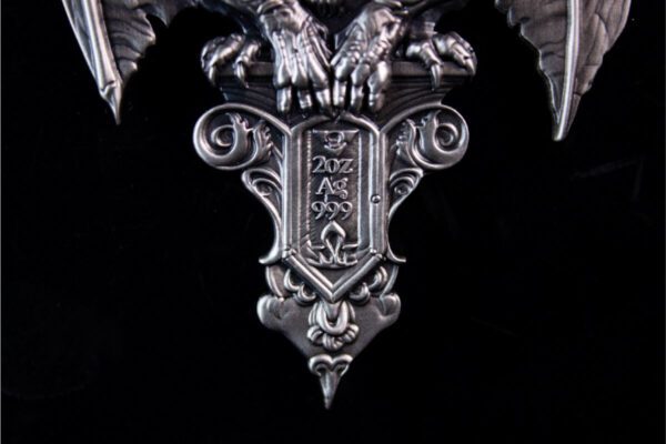 Close-up of the front of the 2025 South Korea Gargoyle 2 oz Silver High Relief Antiqued Stacker against a black background, showing intricate gothic features.