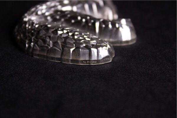Side view of the 2025 South Korea Lowpoly Lunar Snake 2 oz Silver Antiqued Stacker highlighting the engraved .999 silver purity mark.