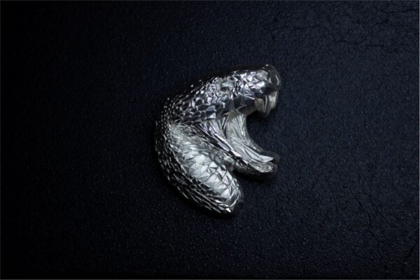Wide view of the 2025 South Korea Lowpoly Lunar Snake 2 oz Silver Antiqued Stacker revealing its full coiled geometry and detailed antiqued surface.