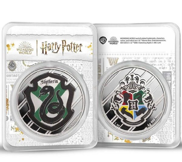Front-facing view of two 2025 Harry Potter 1 oz Silver Colorized Coins in tamper-evident packaging—left shows green Slytherin crest with silver serpent emblem on black background; right features Hogwarts crest with all four house symbols in gold and silver; both housed in clear casing with Harry Potter branding above.