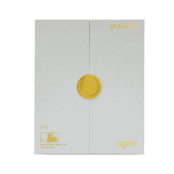 A small, gray cardboard box with a large, embossed gold circle on the front.