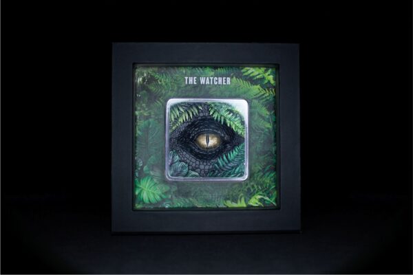 Front of 2025 South Korean The Watcher silver stacker box featuring stylized reptilian eye design with green accents and intricate patterns,