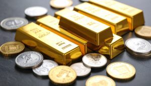 A close-up, artistic shot of various gold and silver bullion products, including bars and rounds, suggesting wealth and investment.