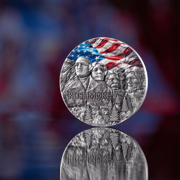Obverse of 2024 Ghana Mount Rushmore Special Edition 2 oz Silver Coin featuring colorized American flag and sculpted portraits of Washington, Jefferson, Roosevelt, and Lincoln.