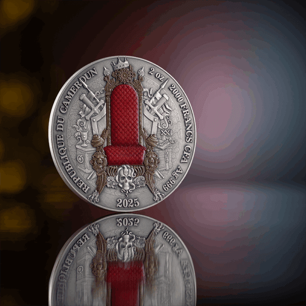 A close-up, back view of the 2025 Cameroon Legacy of the Greatest Empires French Empire 2 oz silver coin, showcasing the national coat of arms of Cameroon. The coin has an antiqued finish and is reflected on a surface.