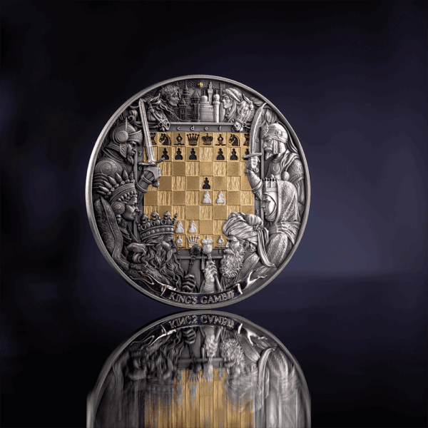 A close-up, front view of the 2025 Niue Chess Battle Kings Gambit 3 oz silver coin. The coin, with its gilded chessboard design, is presented on a reflective dark background.