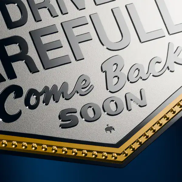 “Close-up of 2026 Niue 2 oz Silver Colorized Gilded Coin featuring ‘Drive Carefully Come Back Soon’ Las Vegas sign in silver and gold”