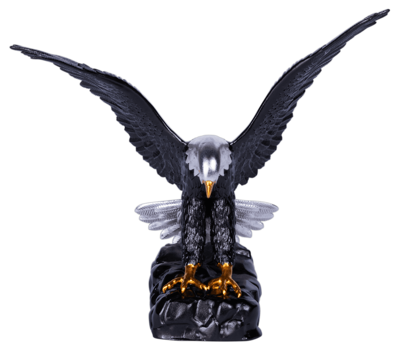 A three-dimensional coin shaped like an eagle, with its wings spread wide in a symmetrical pose. The eagle's body is dark, with silver and colorized details, and its beak and talons are gilded gold. The coin rests on a dark, rocky base.