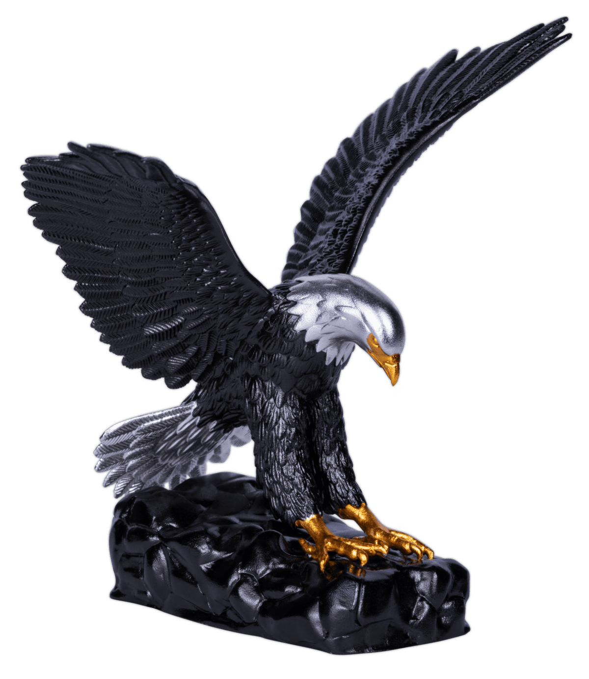 A three-dimensional coin shaped like an eagle, with one wing raised high and the other slightly lower. The eagle's body is dark and colorized, while its beak and talons are gilded gold. The coin rests on a dark, rocky base.
