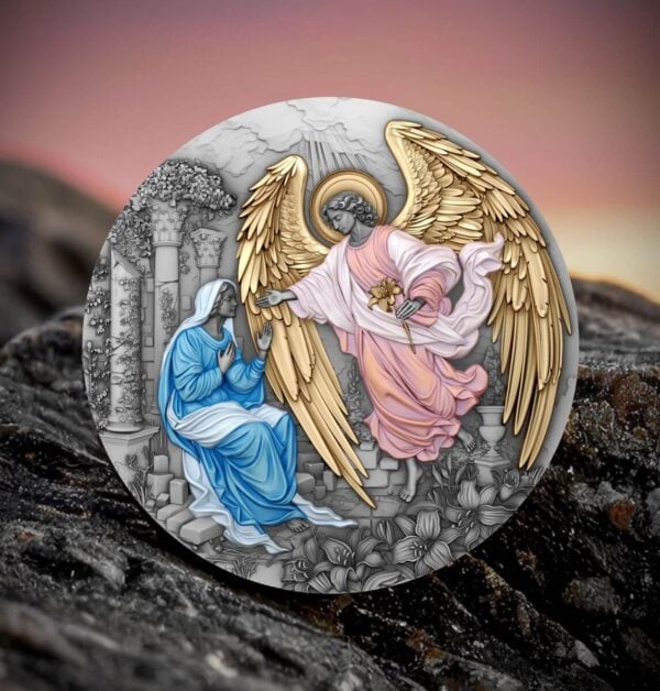 The front of a 2025 Niue "Herald of Salvation - Gabriel" antiqued and gilded silver coin, depicting the Annunciation, placed outdoors on a weathered wooden surface with a soft, sunset-colored sky in the background.