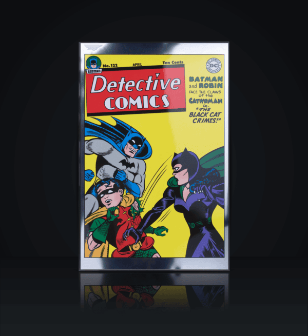 A colorized silver foil coin featuring the cover of Detective Comics #122, depicting Batman, Robin, and Catwoman, set against a dark background with a reflection.