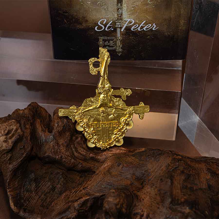 St. Peter collectible coin with gold finish, featuring religious imagery, displayed on a wooden surface.