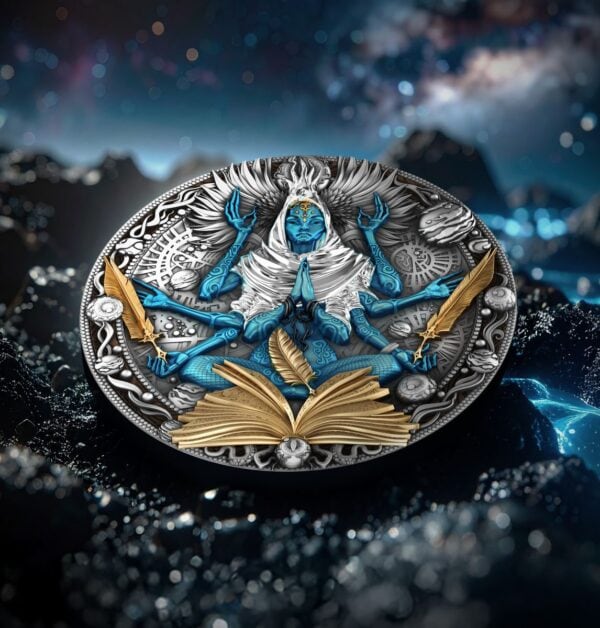 A coin featuring a multi-armed blue figure with gilded elements, including an open book and feathers, lying flat on a dark, rocky surface under a starry sky.