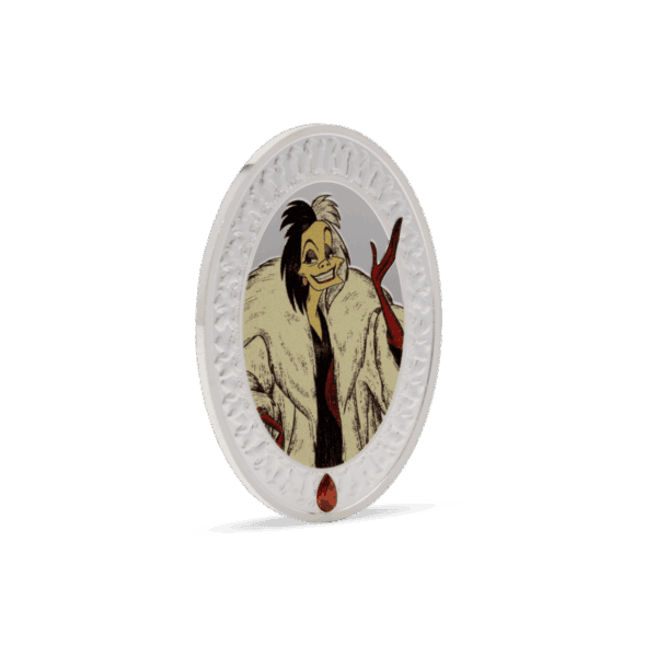 A side view of the 2025 Niue Disney Villains Cruella de Vil coin, showing the thickness of the oval-shaped 2-ounce silver coin with a small, red jewel at the bottom of the front side