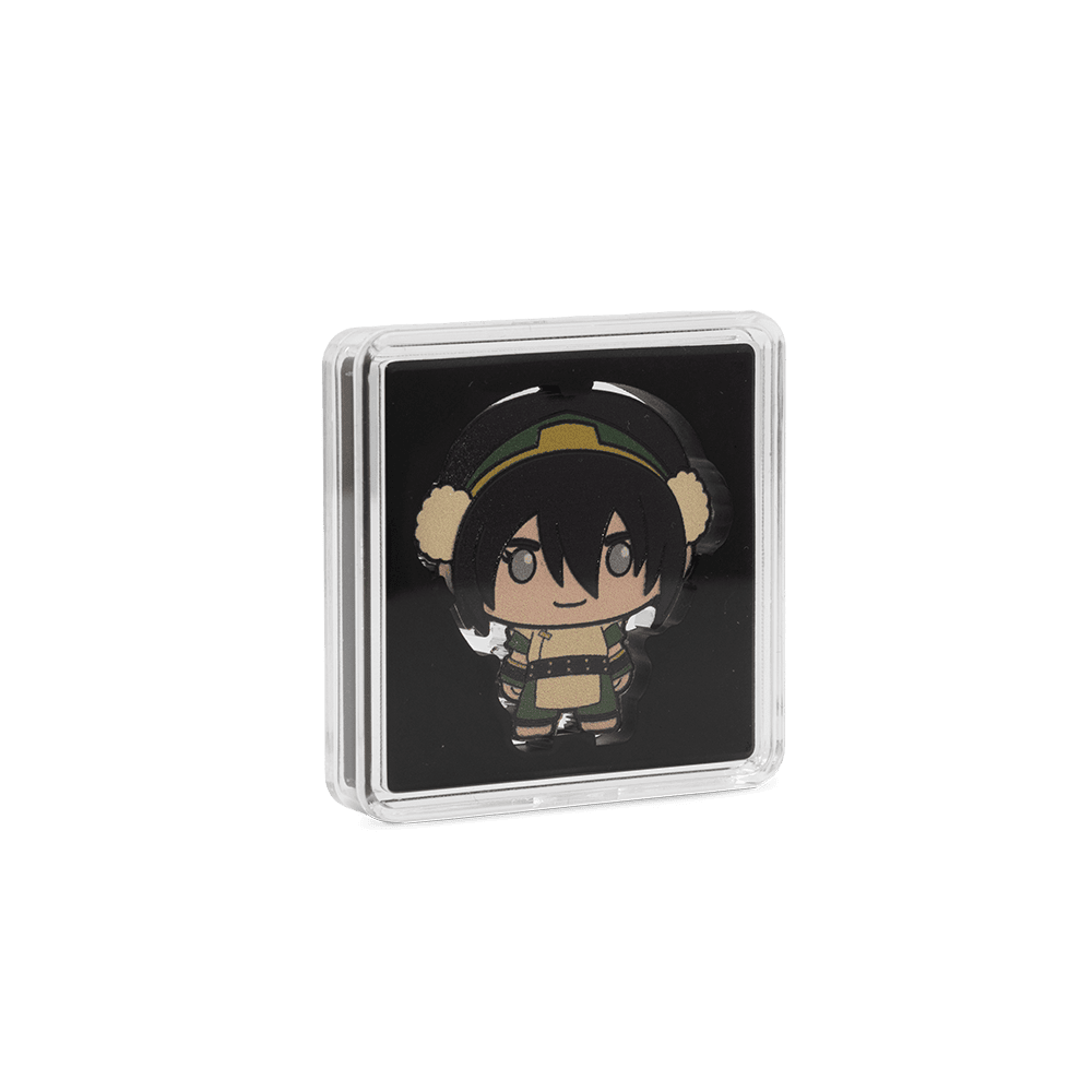 A colorized Toph Beifong chibi coin inside a square, clear protective capsule