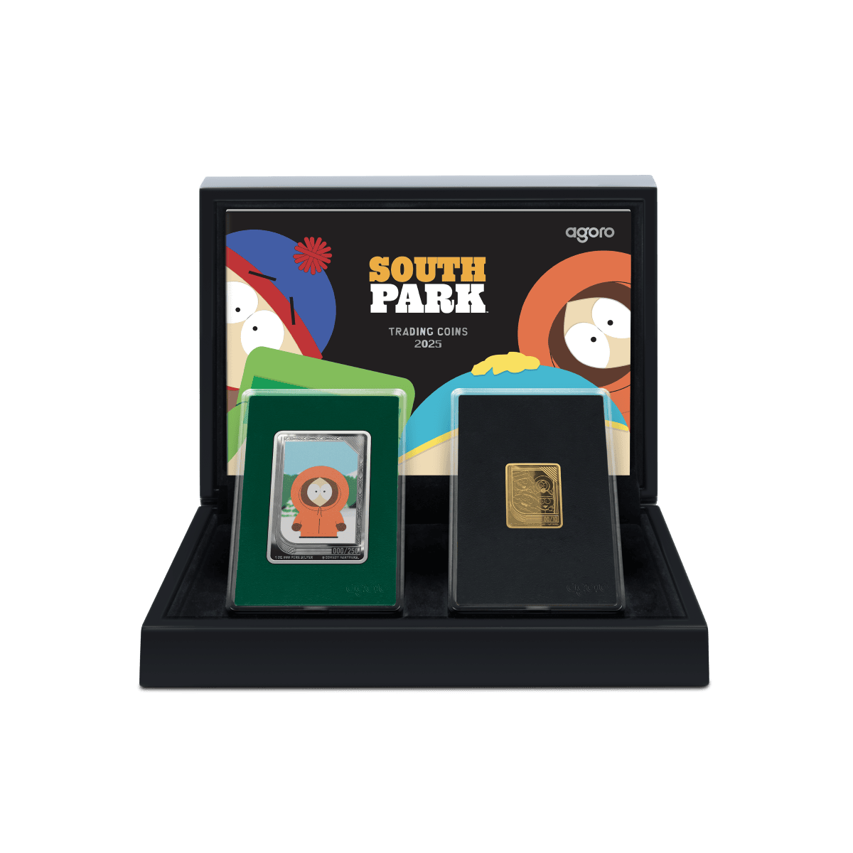 An open, black presentation box for a "South Park" trading coin set. Two rectangular, silver-colored coins are displayed inside, one featuring an image of the character Cartman in a green frame, and the other featuring an image of the character Kenny in a black frame.
