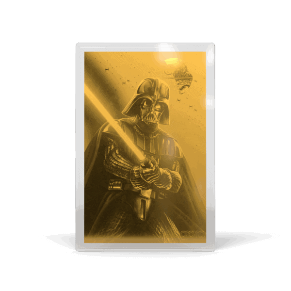 A gold-toned proof foil featuring Darth Vader holding a glowing lightsaber. The image is in a sepia or golden tone, with Darth Vader in the foreground, facing forward, and holding a red lightsaber that casts a glow on his helmet. The background is a blurry, dark image of a Death Star interior. The image looks like a collectible coin or foil.