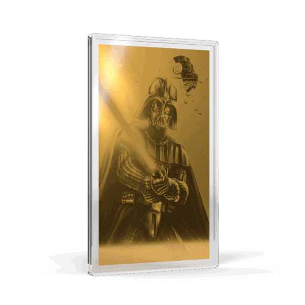 A gold-toned proof foil featuring Darth Vader holding a glowing lightsaber. The foil is tilted to show the left side and front, with the image of Darth Vader visible through the translucent packaging. He is in his full armor, and the glowing red lightsaber he holds casts a light on his helmet and the surrounding area.