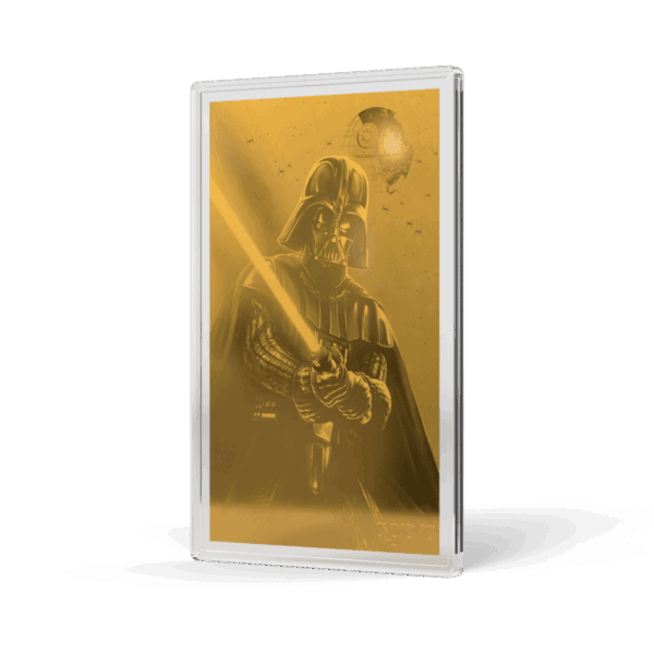 A gold-toned proof foil featuring Darth Vader holding a glowing lightsaber. The foil is tilted to show the right side and front, with the image of Darth Vader visible through the translucent packaging. He is in his full armor, and the glowing red lightsaber he holds casts a light on his helmet and the surrounding area.