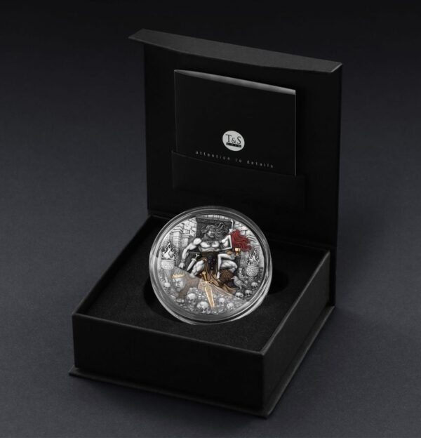 High-quality collectible coin in black presentation box with detailed design featuring a mythological figure, red accents, and intricate background elements for collectors.