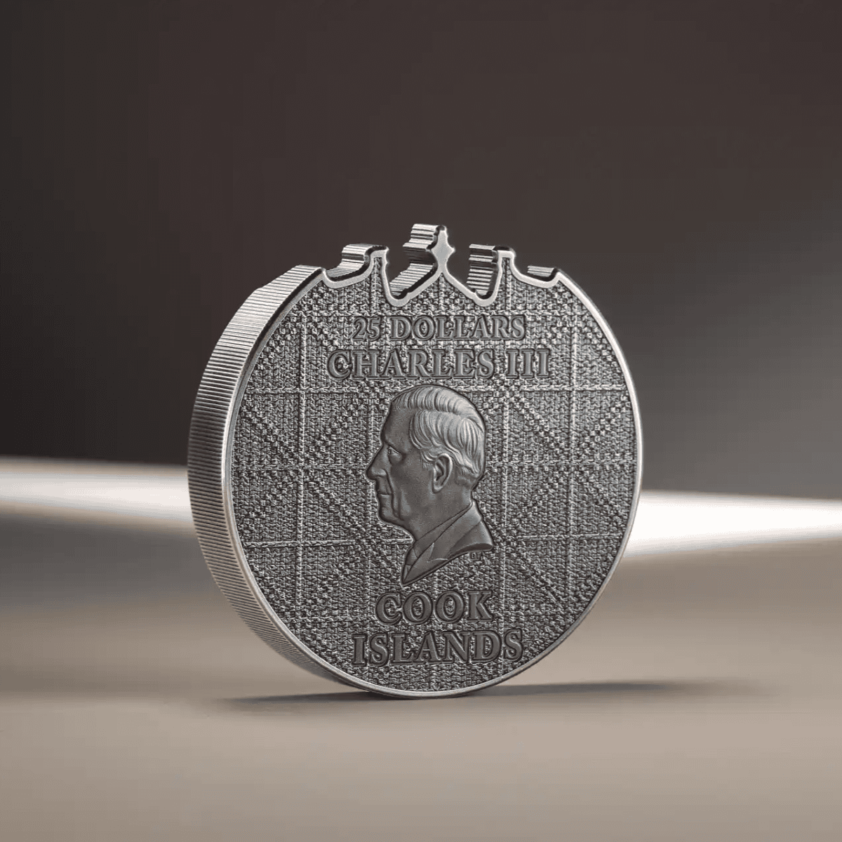 Shaped Silver coin replica featuring Charles III with textured background and descriptive engravings.