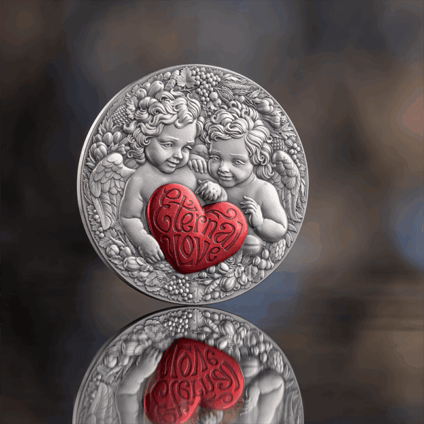 Ornate silver medal with angelic children holding a red heart inscribed with "Eternal Love".