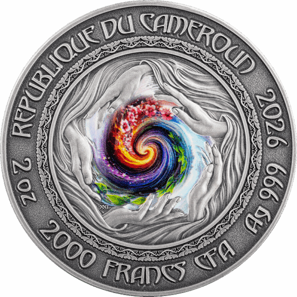 Vibrant swirl of colors in the center of a silver coin with hands surrounding the design.