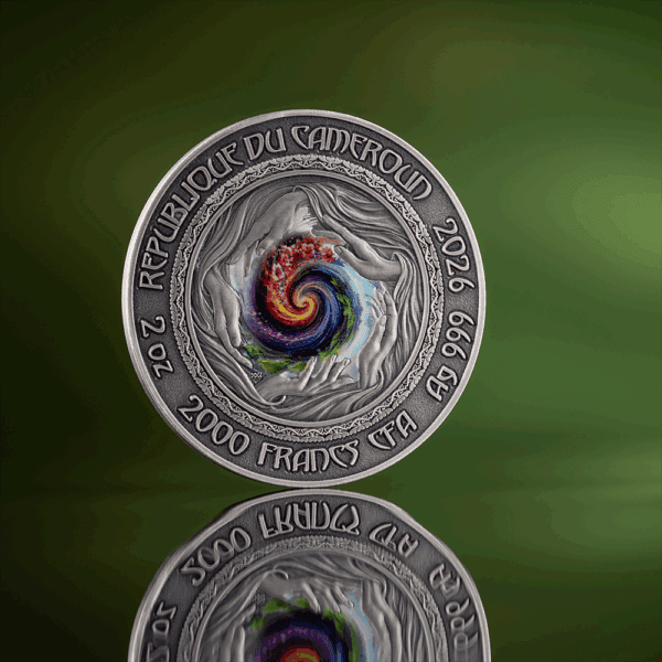 2026-66-99-AB 2000 Francs coin from the Republic of Cote d'Ivoire with colorful spiral design and hands motif, reflecting cultural art and currency.