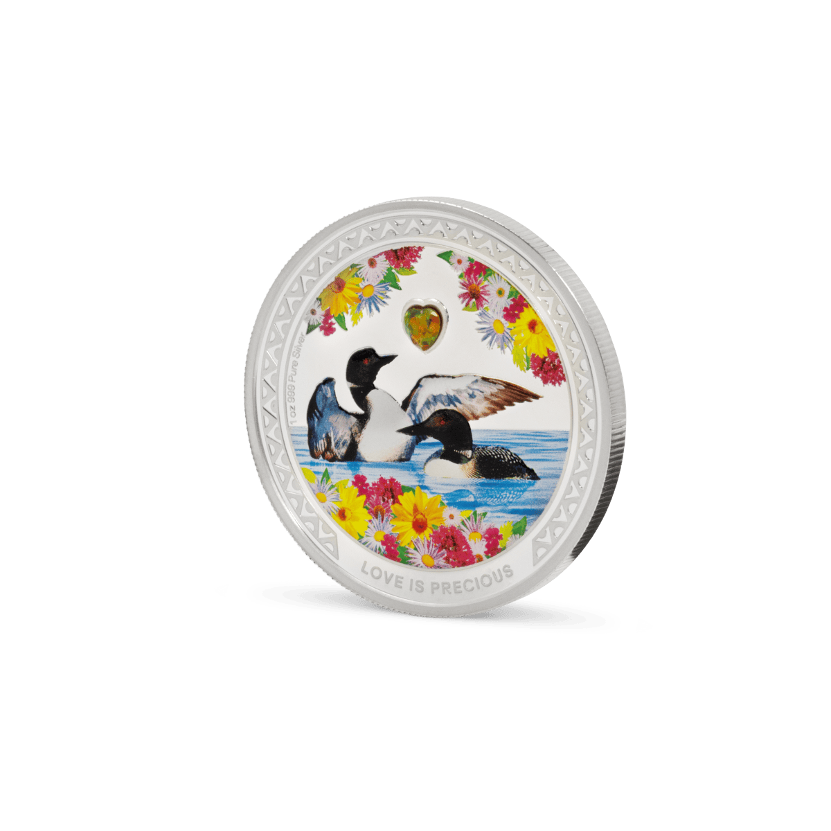 Colorful coin featuring two ducks in water, surrounded by vibrant flowers and a heart-shaped gemstone, with the inscription "LOVE IS PRECIOUS.".