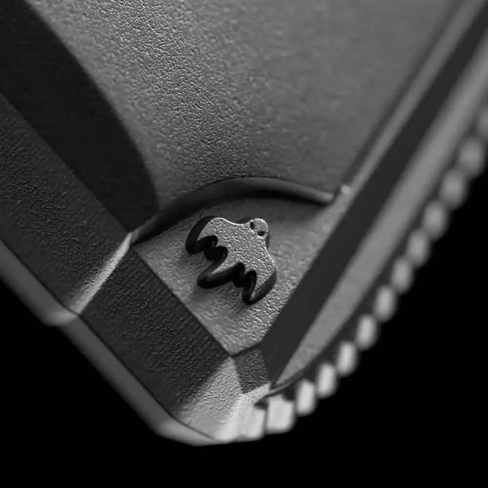 Detailed image of a textured vintage silver coin featuring a small ornate pistol charm.