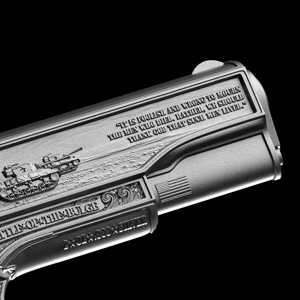 A highly detailed, silver 3D-shaped coin featuring a vintage pistol and military imagery, with engraved patriotic inscriptions.