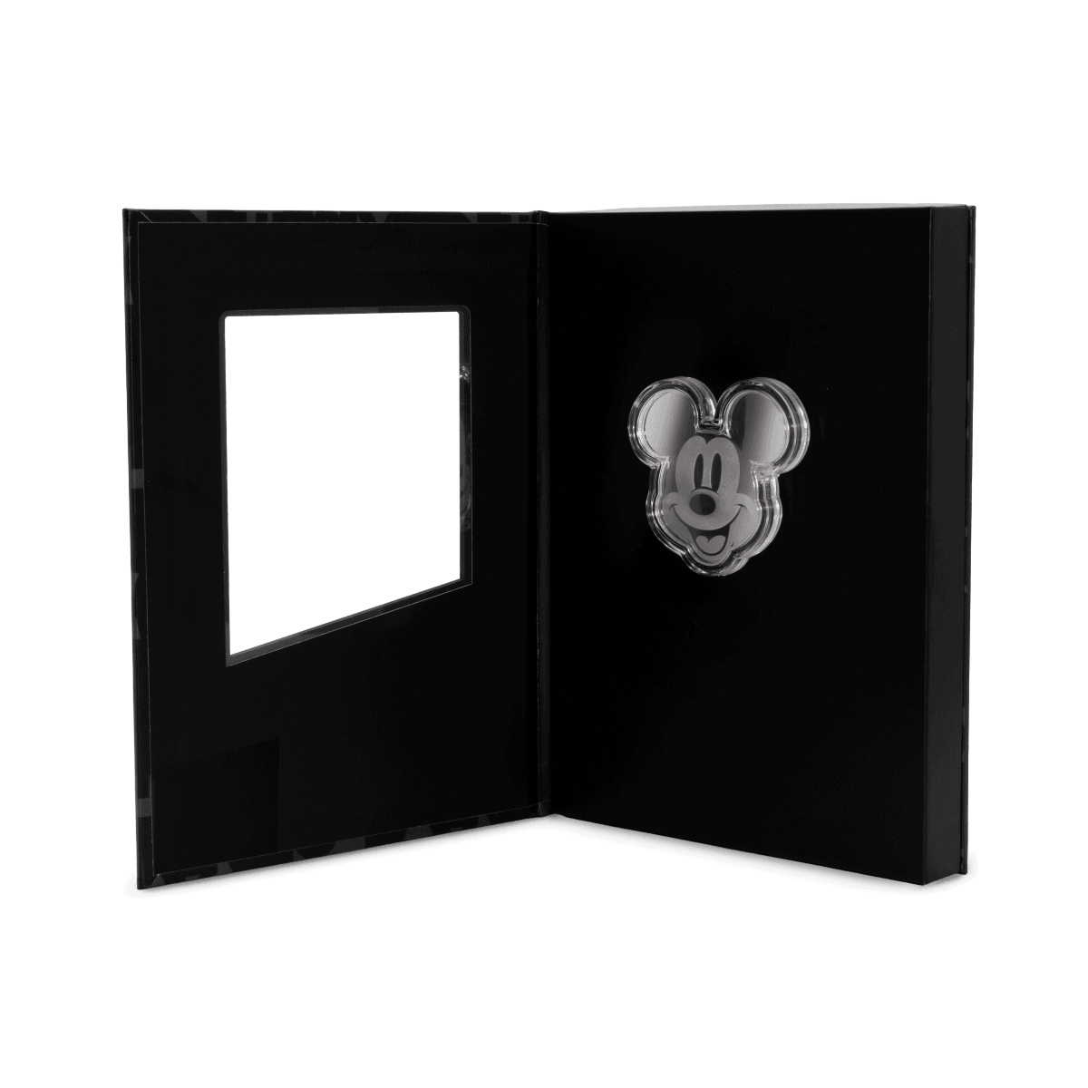 Brightly detailed Mickey Mouse face on silver proof coin in black display case, celebrating Disney's iconic character.