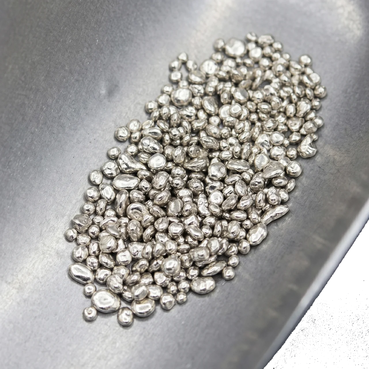 Shiny 18K white gold casting grain, 2 grams, from 2023, minted by XYZ, shown from an angled perspective highlightin.